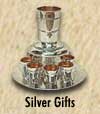 Kiddush cups, candlesticks, spice boxes, challah knives, Chanukah menorahs, honey dishes, seder plates, talis clips.